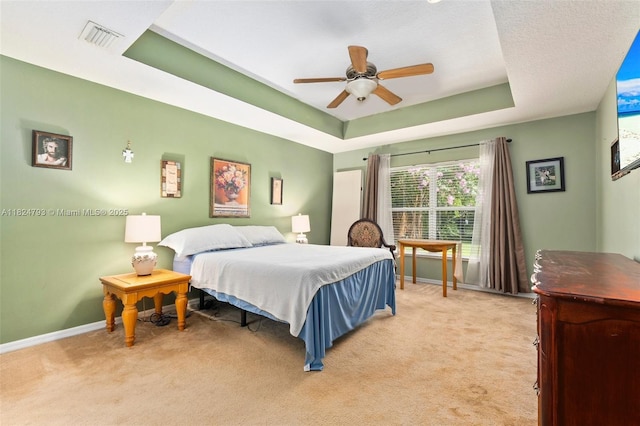 1025 SW Placetas Ave, Port St Lucie, FL 34953 - bedroom featuring light colored carpet, a tray ceiling, and a ceiling fan