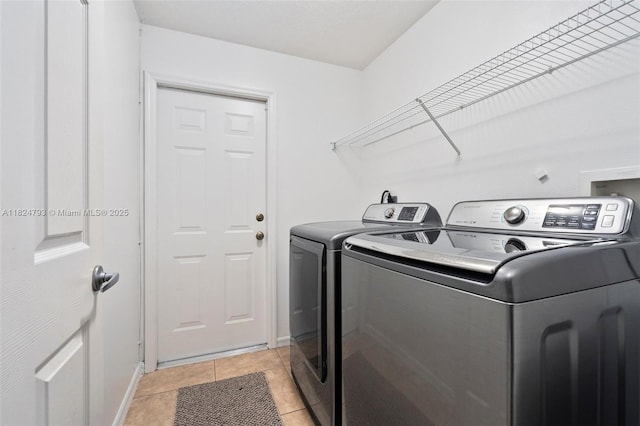 1025 SW Placetas Ave, Port St Lucie, FL 34953 - laundry room featuring washing machine and dryer and light tile patterned floors