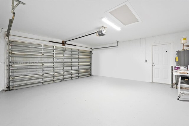 1025 SW Placetas Ave, Port St Lucie, FL 34953 - garage with a garage door opener and water heater