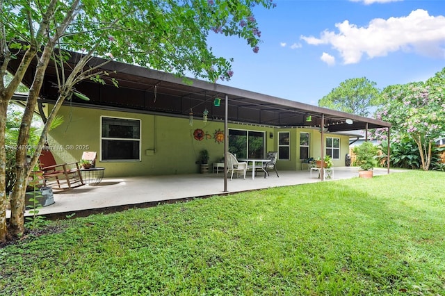 1025 SW Placetas Ave, Port St Lucie, FL 34953 - rear view of house with a patio area, a lawn, and stucco siding