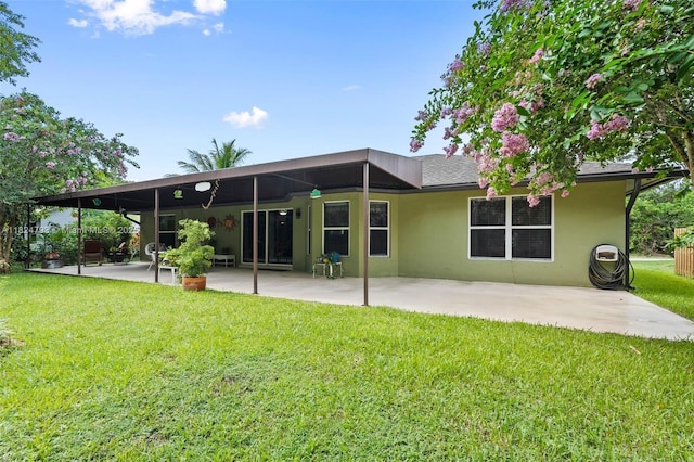 1025 SW Placetas Ave, Port St Lucie, FL 34953 - back of house featuring a patio, stucco siding, and a lawn