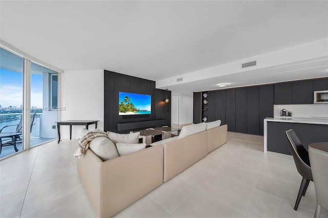 401 N Birch Rd Unit 1100, Fort Lauderdale, FL 33304 - living area with expansive windows, light tile patterned flooring, an accent wall, and wood walls