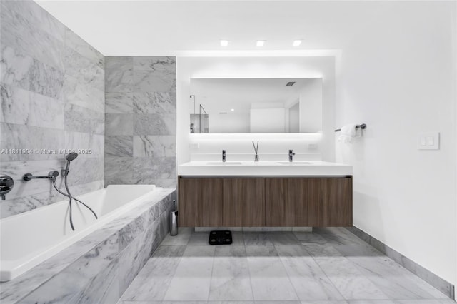 401 N Birch Rd Unit 1100, Fort Lauderdale, FL 33304 - bathroom with double vanity, a bath, and marble finish floors