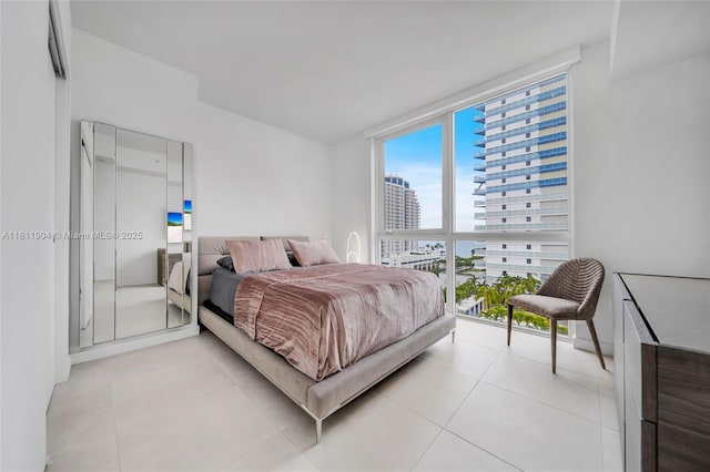 401 N Birch Rd Unit 1100, Fort Lauderdale, FL 33304 - bedroom with a wall of windows, light tile patterned floors, and a view of city