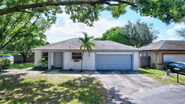 1077 SW 120th Ave, Davie, FL 33325 - ranch-style home with stucco siding, a garage, and asphalt driveway