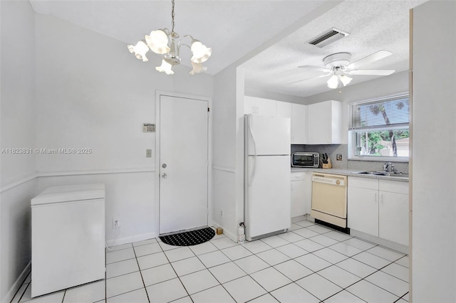1077 SW 120th Ave, Davie, FL 33325 - kitchen featuring white appliances, ceiling fan, light countertops, white cabinets, and a chandelier