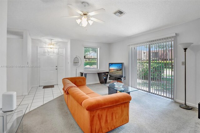 1077 SW 120th Ave, Davie, FL 33325 - living area featuring ceiling fan, light tile patterned floors, light carpet, and a textured ceiling