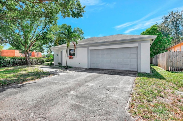 1077 SW 120th Ave, Davie, FL 33325 - ranch-style house with stucco siding, a garage, and asphalt driveway