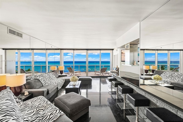 4779 Collins Ave Unit 702, Miami Beach, FL 33140 - living area featuring expansive windows and a water view