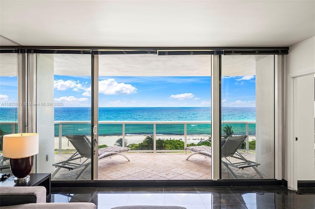 4779 Collins Ave Unit 702, Miami Beach, FL 33140 - living area featuring a wall of windows and a water view
