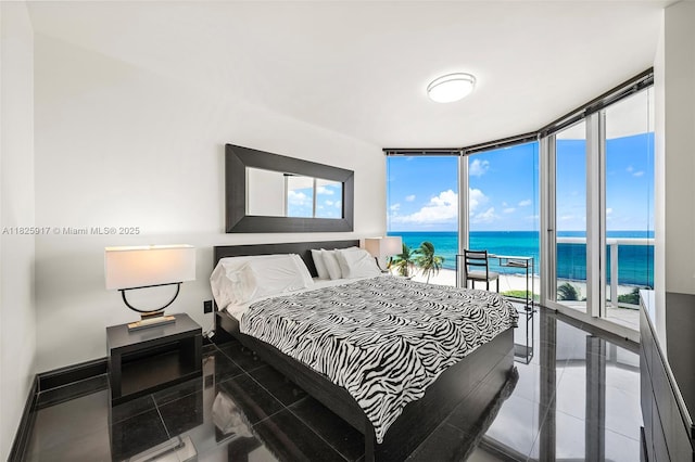 4779 Collins Ave Unit 702, Miami Beach, FL 33140 - bedroom featuring a water view and a wall of windows