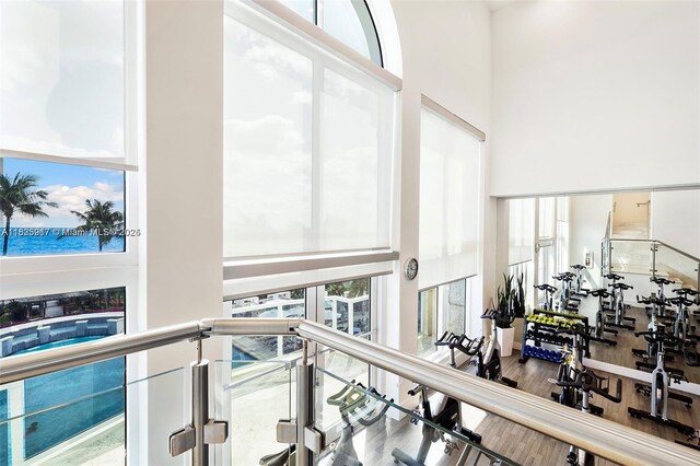 4779 Collins Ave Unit 702, Miami Beach, FL 33140 - workout area with a towering ceiling and wood finished floors