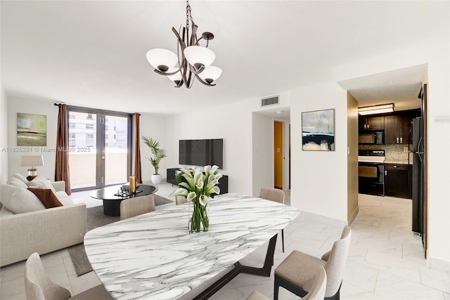 1621 Collins Ave Unit 708, Miami Beach, FL 33139 - dining space featuring light marble finish flooring and a chandelier