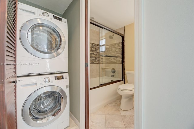 1621 Collins Ave Unit 708, Miami Beach, FL 33139 - laundry area featuring stacked washer and clothes dryer and tile patterned floors