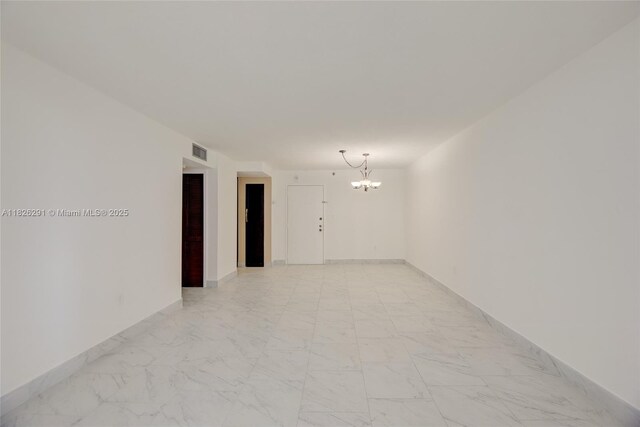 1621 Collins Ave Unit 708, Miami Beach, FL 33139 - empty room featuring a chandelier and light marble finish flooring