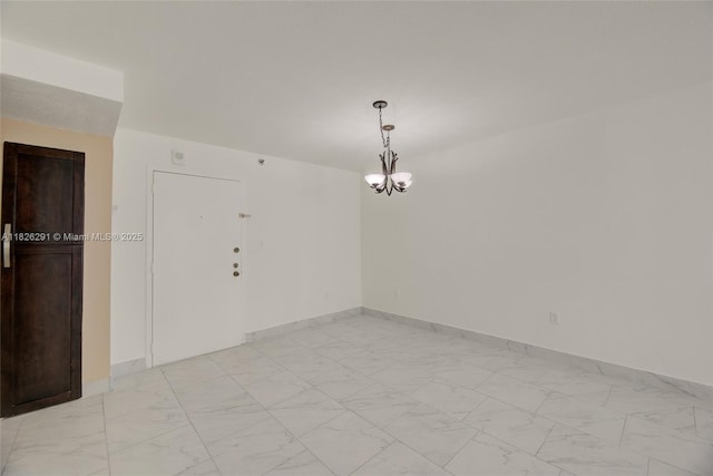 1621 Collins Ave Unit 708, Miami Beach, FL 33139 - spare room featuring light marble finish flooring and a chandelier