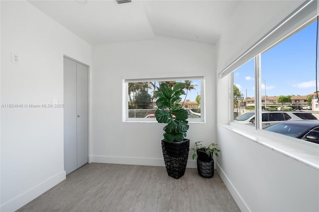 5290 Palm Ave, Hialeah, FL 33012 - spare room with wood finished floors, healthy amount of natural light, and lofted ceiling