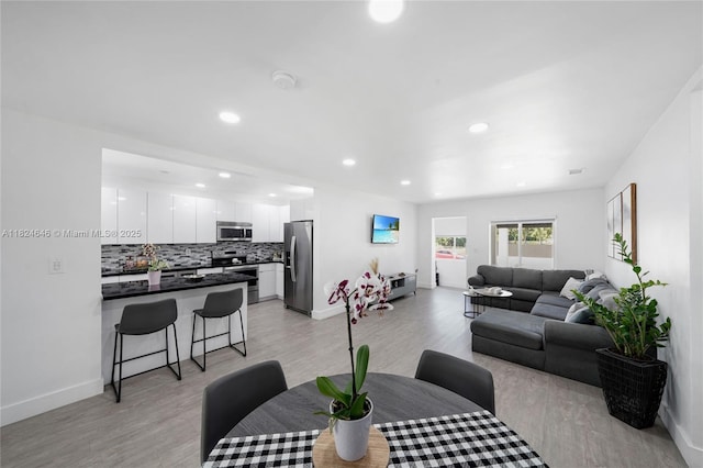 5290 Palm Ave, Hialeah, FL 33012 - dining room with light wood-style flooring and recessed lighting