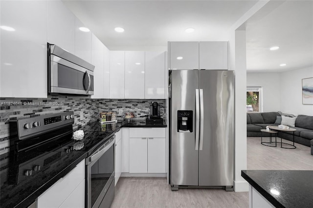 5290 Palm Ave, Hialeah, FL 33012 - kitchen featuring stainless steel appliances, light wood-style flooring, modern cabinets, backsplash, and white cabinetry
