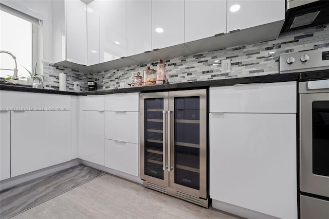 5290 Palm Ave, Hialeah, FL 33012 - indoor bar featuring wine cooler, backsplash, light wood-style flooring, and wall oven