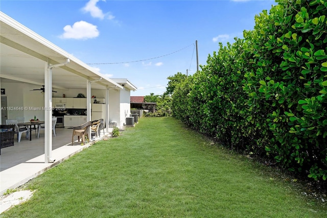 5290 Palm Ave, Hialeah, FL 33012 - view of grassy yard with ceiling fan and a patio