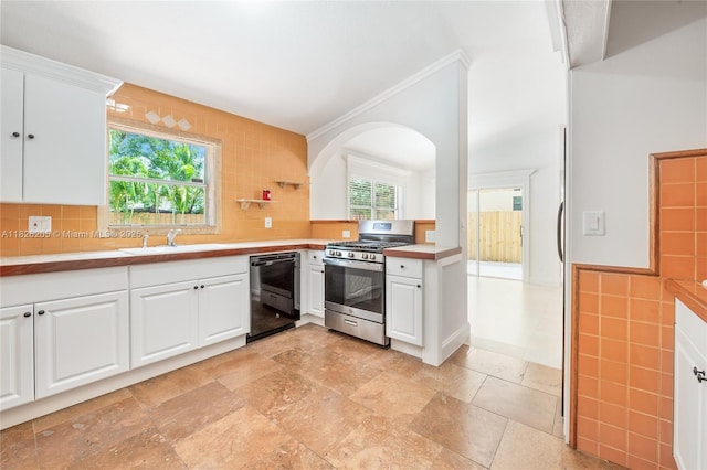 14711 SW 170th Ter, Miami, FL 33187 - kitchen with dishwasher, stainless steel range with gas cooktop, plenty of natural light, white cabinets, and ornamental molding