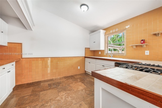 14711 SW 170th Ter, Miami, FL 33187 - kitchen featuring tile walls, white cabinetry, lofted ceiling, dark stone finish flooring, and tile countertops