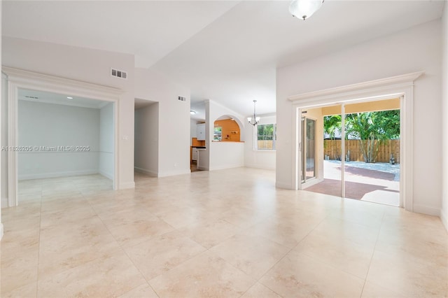 14711 SW 170th Ter, Miami, FL 33187 - empty room with lofted ceiling, a chandelier, light tile patterned flooring, and arched walkways