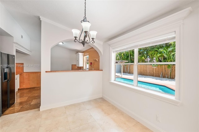 14711 SW 170th Ter, Miami, FL 33187 - unfurnished dining area featuring arched walkways, a chandelier, light tile patterned floors, and crown molding