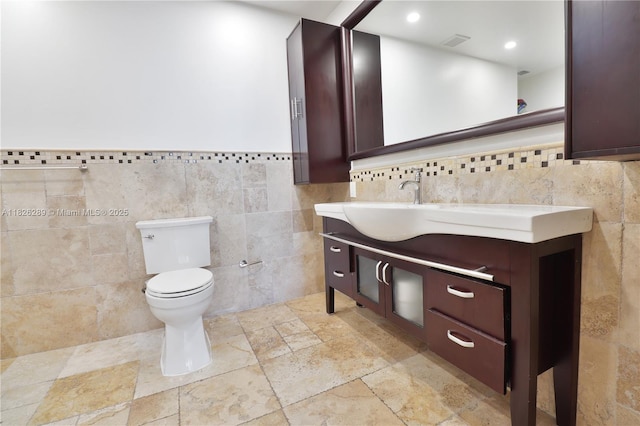 6770 Indian Creek Dr Unit Te, Miami Beach, FL 33141 - bathroom featuring tile walls, vanity, stone tile flooring, a wainscoted wall, and recessed lighting