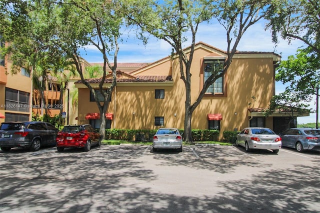 15549 N Miami Lakeway N Unit 104, Miami Lakes, FL 33014 - view of building exterior with uncovered parking