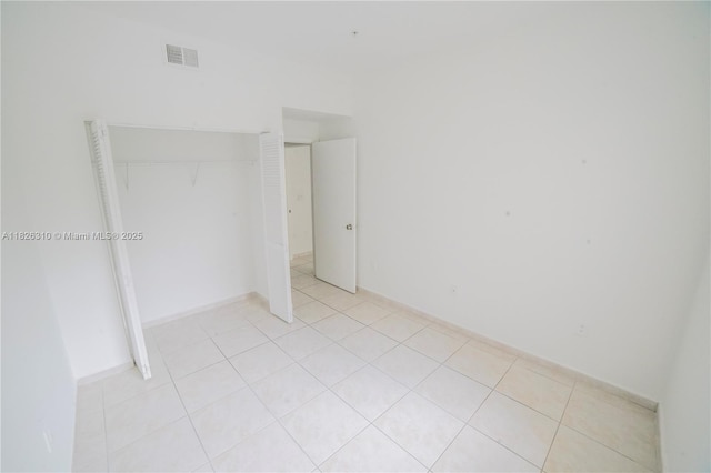 7200 NW 114th Ave Unit 305, Doral, FL 33178 - unfurnished bedroom featuring light tile patterned floors and a closet