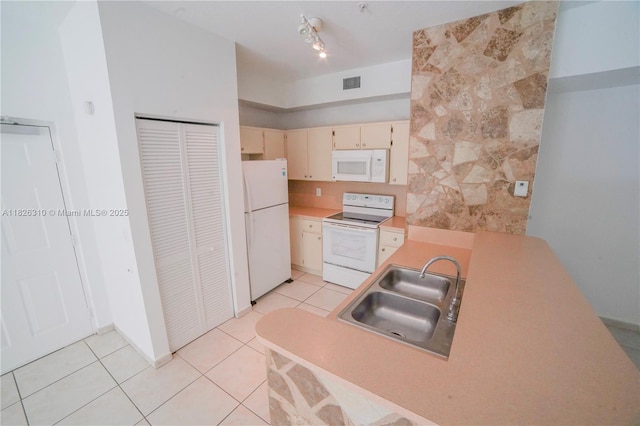 7200 NW 114th Ave Unit 305, Doral, FL 33178 - kitchen with white appliances, light tile patterned floors, cream cabinets, light countertops, and a peninsula