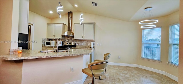 1948 Redmont Ave, Lehigh Acres, FL 33972 - kitchen featuring white microwave, lofted ceiling, a breakfast bar, backsplash, and light countertops