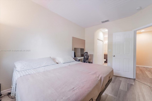370 Lake Monterey Cir, Boynton Beach, FL 33426 - bedroom with arched walkways and light wood-type flooring