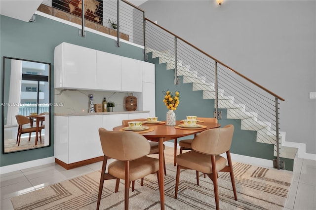 1111 SW 1st Ave Unit 721-N, Miami, FL 33130 - dining room featuring stairway, a high ceiling, and light tile patterned floors
