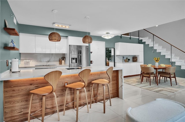 1111 SW 1st Ave Unit 721-N, Miami, FL 33130 - kitchen with modern cabinets, stainless steel refrigerator with ice dispenser, open shelves, and light countertops