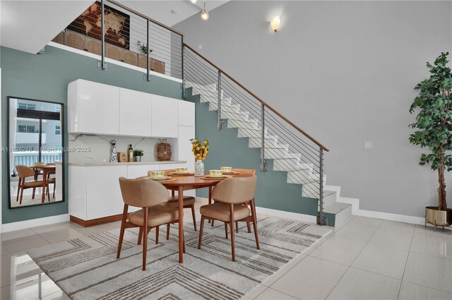 1111 SW 1st Ave Unit 721-N, Miami, FL 33130 - dining area with stairs, light tile patterned flooring, and a towering ceiling
