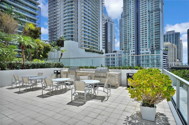 1111 SW 1st Ave Unit 721-N, Miami, FL 33130 - view of patio with exterior kitchen, a city view, and outdoor dining area