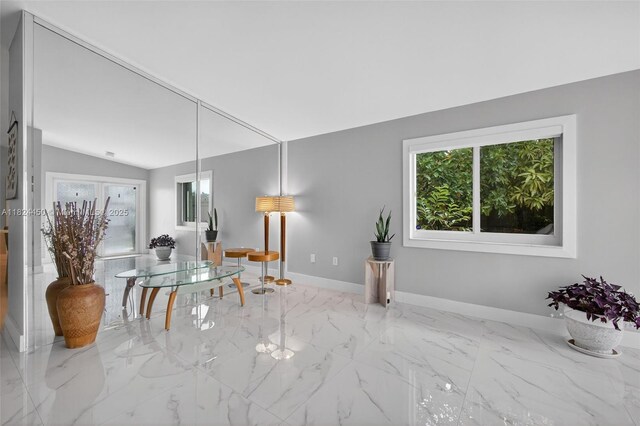 8905 NW 112th St, Hialeah Gardens, FL 33018 - dining area featuring healthy amount of natural light, vaulted ceiling, and marble finish floors