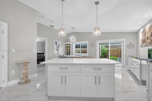 8905 NW 112th St, Hialeah Gardens, FL 33018 - kitchen with light marble finish flooring, white cabinetry, decorative light fixtures, light countertops, and recessed lighting