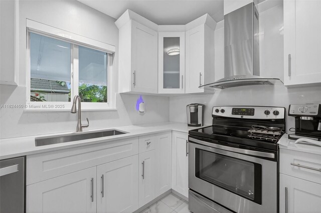 8905 NW 112th St, Hialeah Gardens, FL 33018 - kitchen featuring stainless steel appliances, wall chimney exhaust hood, white cabinets, and light countertops