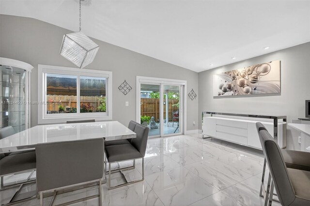 8905 NW 112th St, Hialeah Gardens, FL 33018 - dining room with light marble finish floors, vaulted ceiling, and recessed lighting