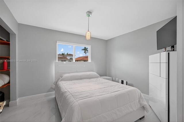 8905 NW 112th St, Hialeah Gardens, FL 33018 - bedroom with baseboards and light marble finish floors