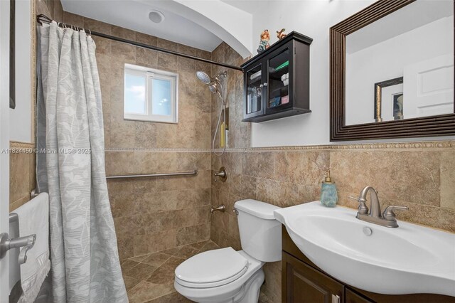 8905 NW 112th St, Hialeah Gardens, FL 33018 - bathroom featuring tile walls, a tile shower, vanity, and a wainscoted wall