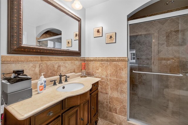 8905 NW 112th St, Hialeah Gardens, FL 33018 - full bathroom with tile walls, vanity, a stall shower, and a wainscoted wall