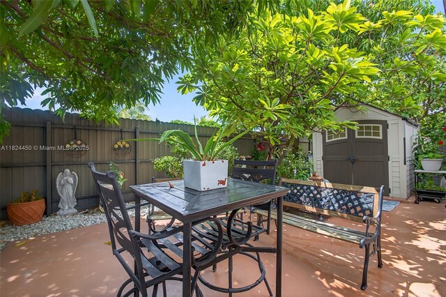 8905 NW 112th St, Hialeah Gardens, FL 33018 - fenced backyard with outdoor dining space, a storage unit, and a patio