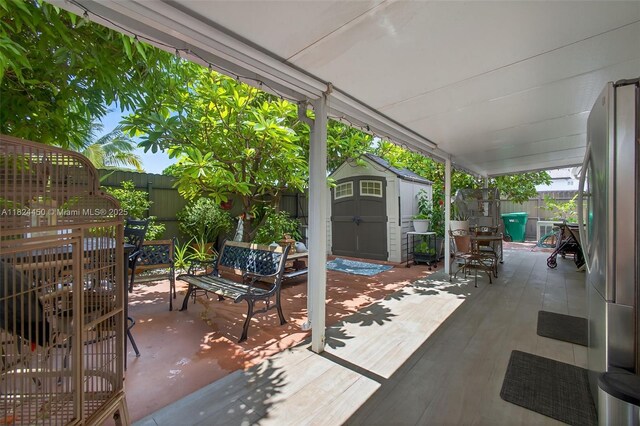 8905 NW 112th St, Hialeah Gardens, FL 33018 - fenced backyard featuring a storage unit and a patio