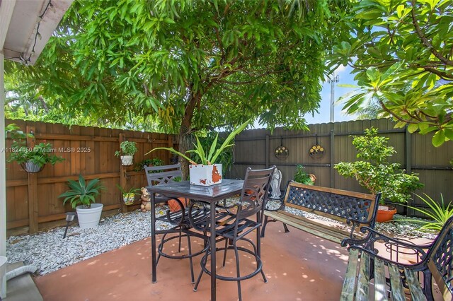 8905 NW 112th St, Hialeah Gardens, FL 33018 - fenced backyard featuring a patio and outdoor dining space