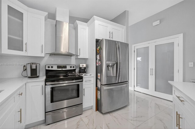 8905 NW 112th St, Hialeah Gardens, FL 33018 - kitchen with appliances with stainless steel finishes, wall chimney range hood, light countertops, and white cabinets